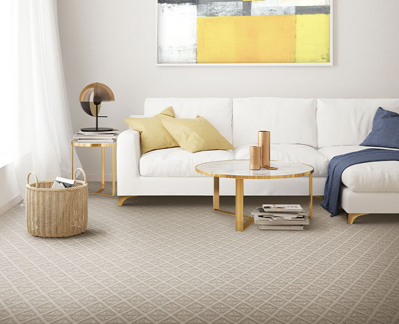 patterned beige carpet in living room with gold and colorful decor.